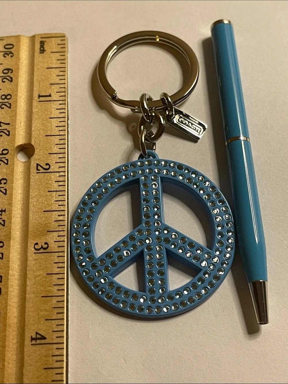 Coach Light Blue Crystal Peace Sign Keyring and Coach Pen